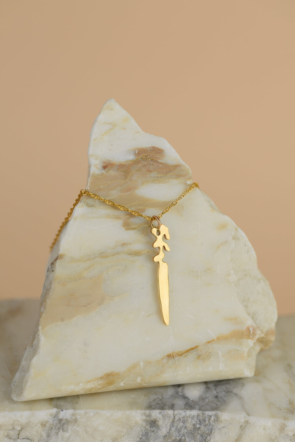 Landmass shaped Dagger sits on a triangle shaped piece of marble