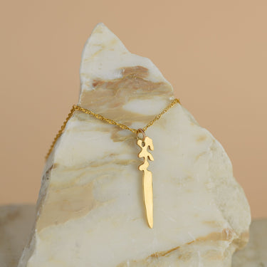Landmass shaped Dagger sits on a triangle shaped piece of marble