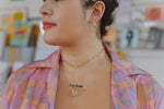 Load image into Gallery viewer, Model wearing landmass cuff earrings in sterling silver and Apophyllite oval link collar necklace in gold. 

