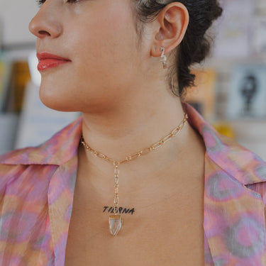 Model wearing landmass cuff earrings in sterling silver and Apophyllite oval link collar necklace in gold. 