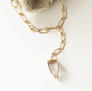 Close up of apophyllte necklace against a white background.