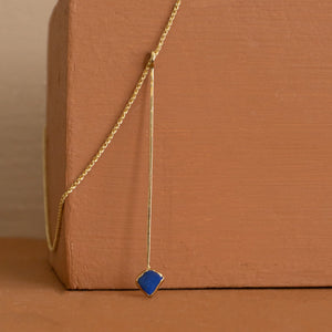 Lapis Lazuli Crystal Point Necklace against a burnt orange block